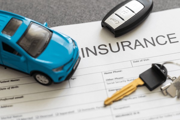 Image of a car and insurance policy.