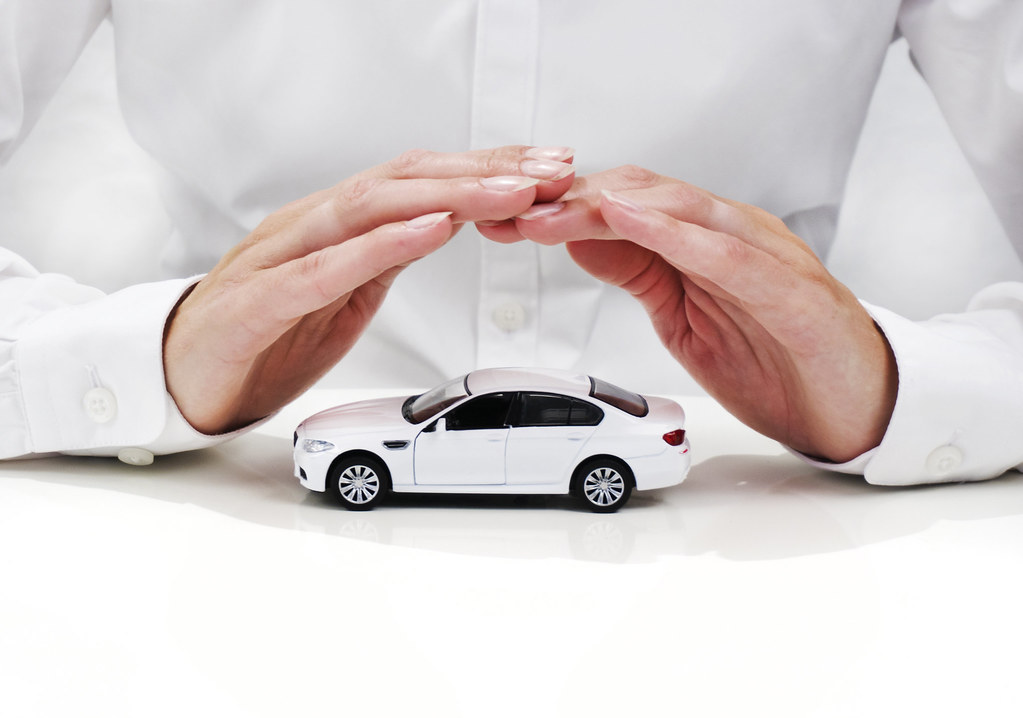 Image of hands protecting a car.