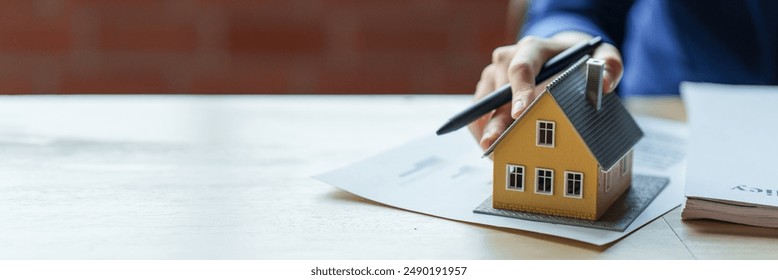 Image of a person signing a home insurance document.